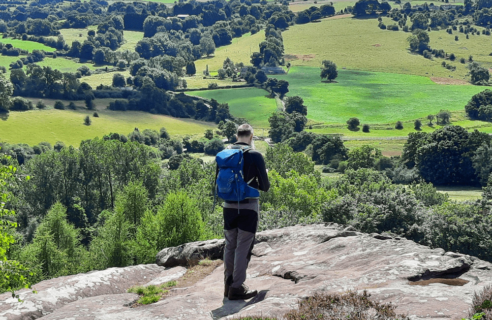Person and view from Cratcliff Crags Robin Hood Stride Peak District